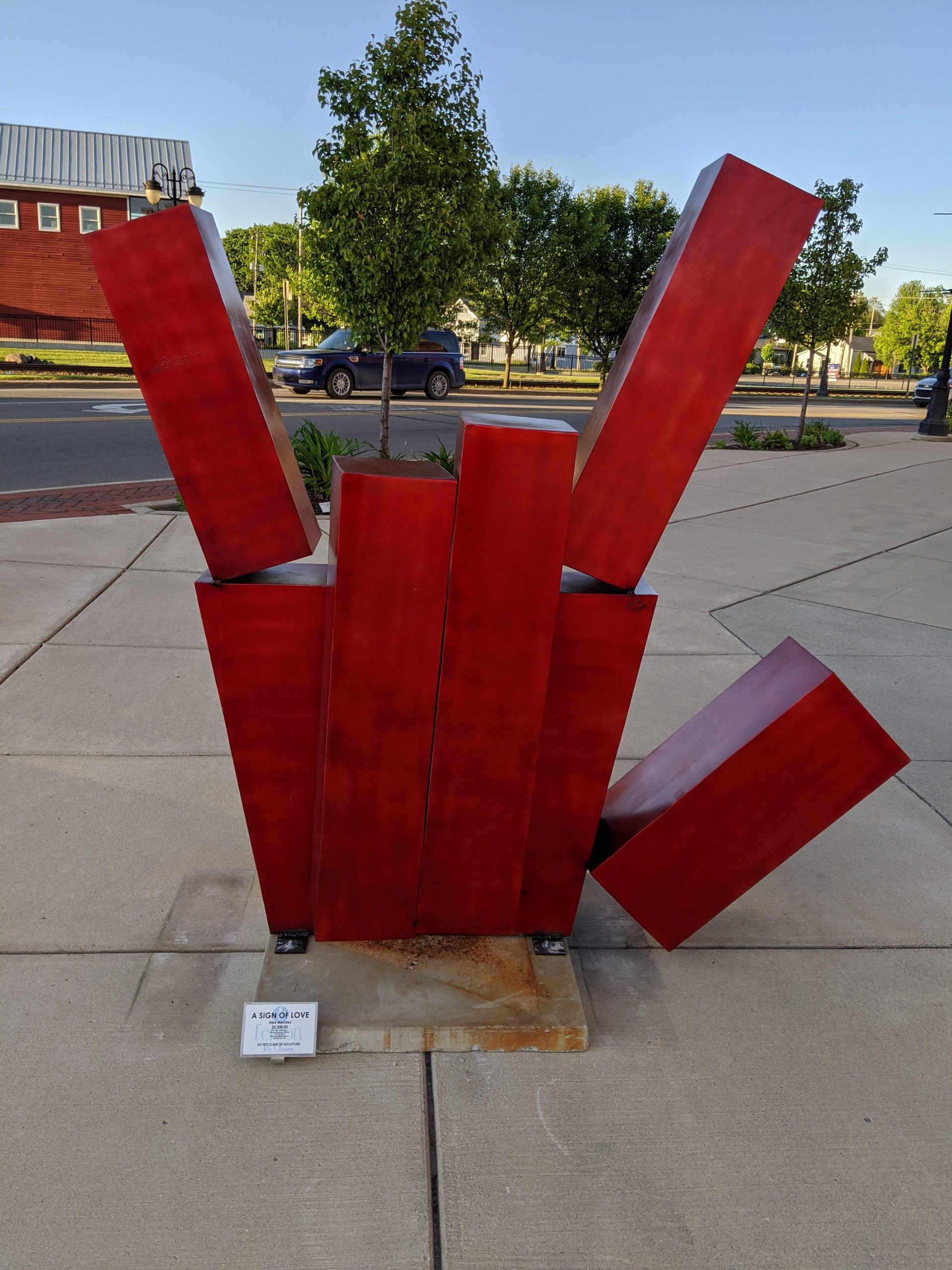 Picture of red sculpture shaped like the handshape for "love" ASL